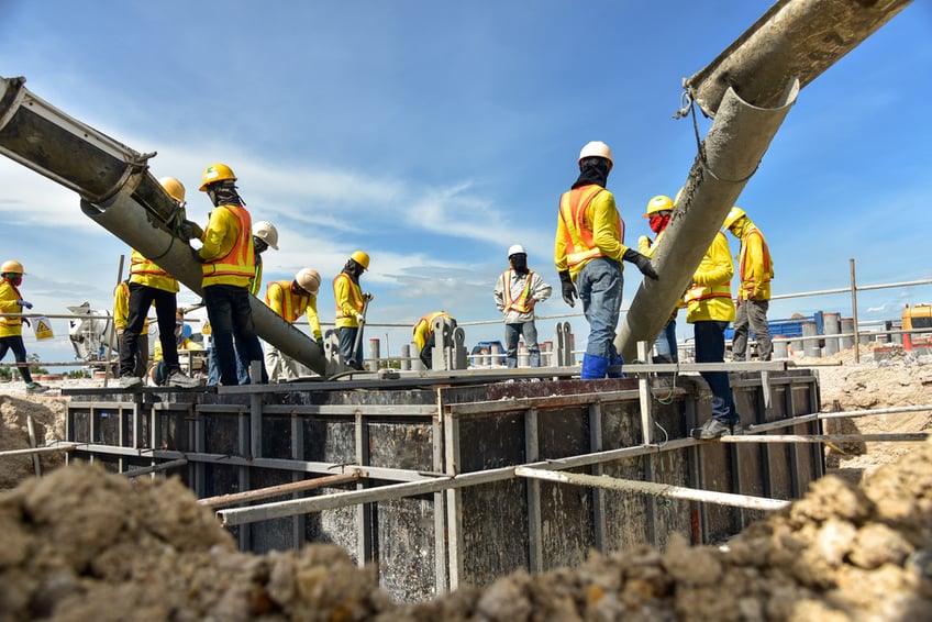 Concrete rates-Construction worker Concrete pouring during commercial concreting floors of building in construction site and Civil Engineer or Construction engineer inspec work