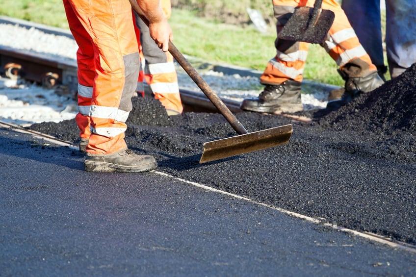 Workers on a road construction, industry and teamwork