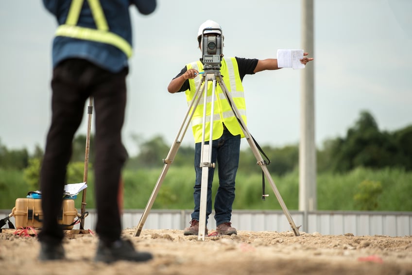 Survey engineer in construction site use theodolite mark a concrete pile co ordinate in construction site