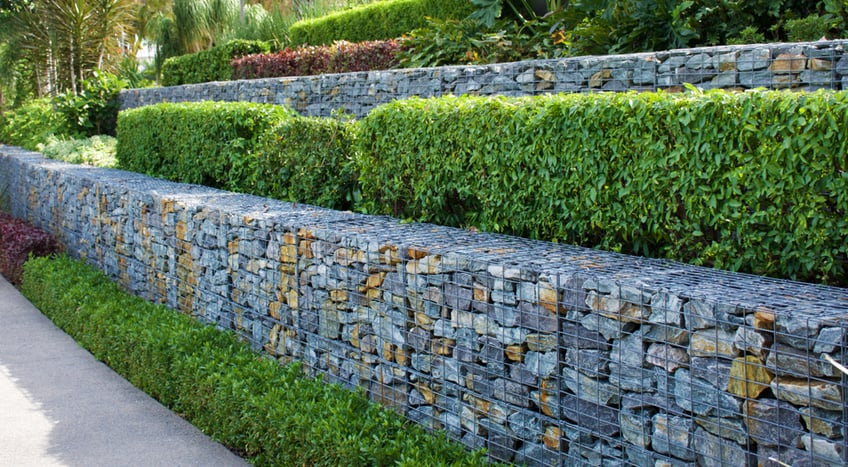 Rock and wire gabions used as retaining walls in a multi tiered garden design