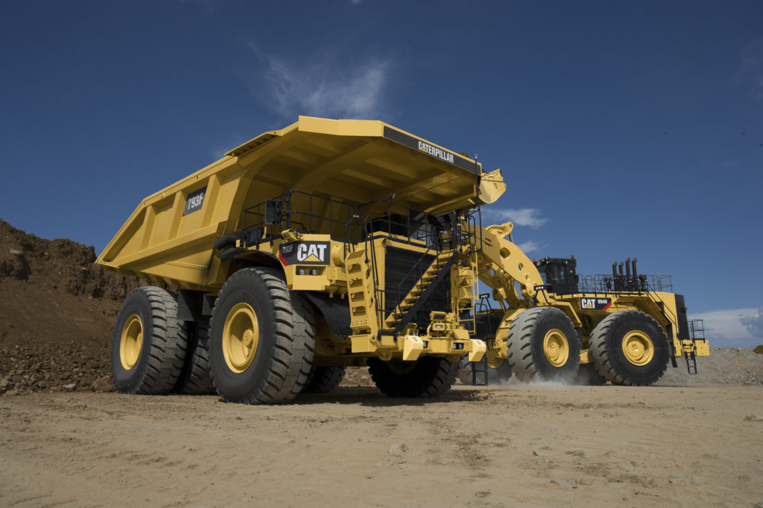 Cat-793F-mining-truck-being-loaded-by-Cat-wheel-loader-1100x733